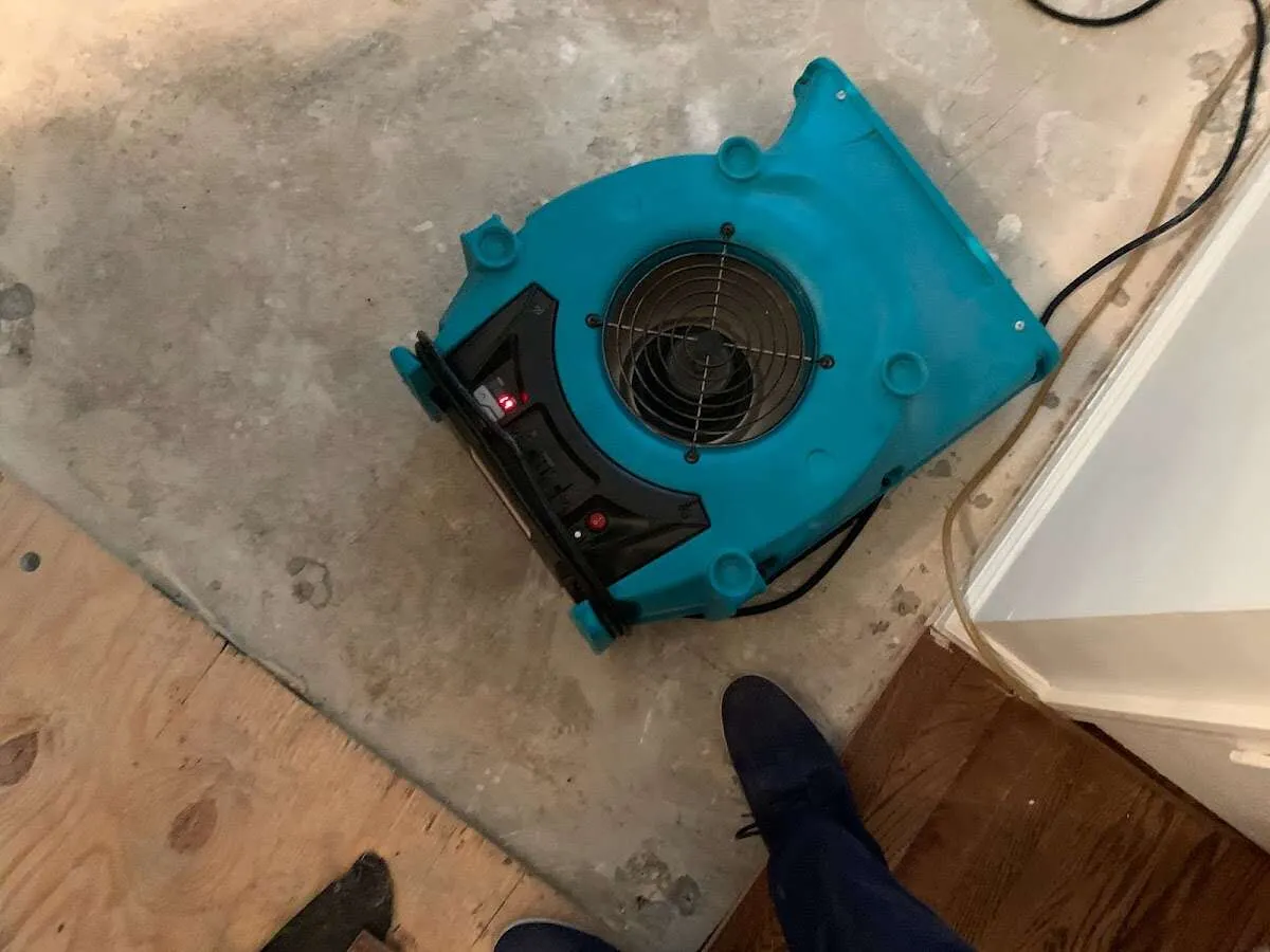 Air mover drying subfloor during Commercial Water Damage Restoration in Del Aire